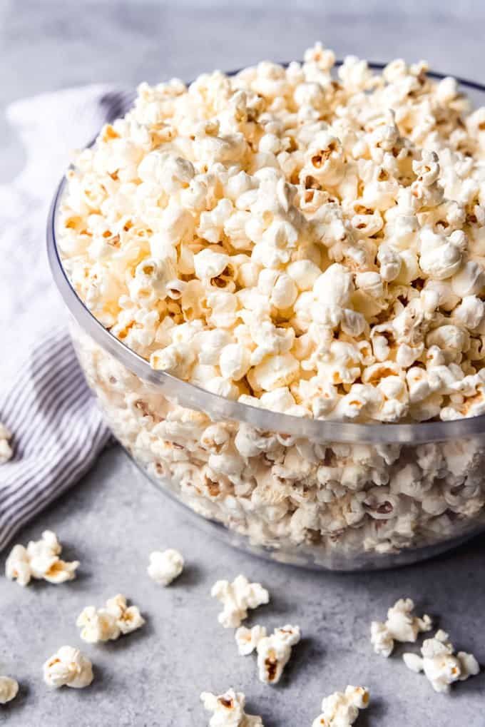 This may contain: a bowl filled with popcorn sitting on top of a table