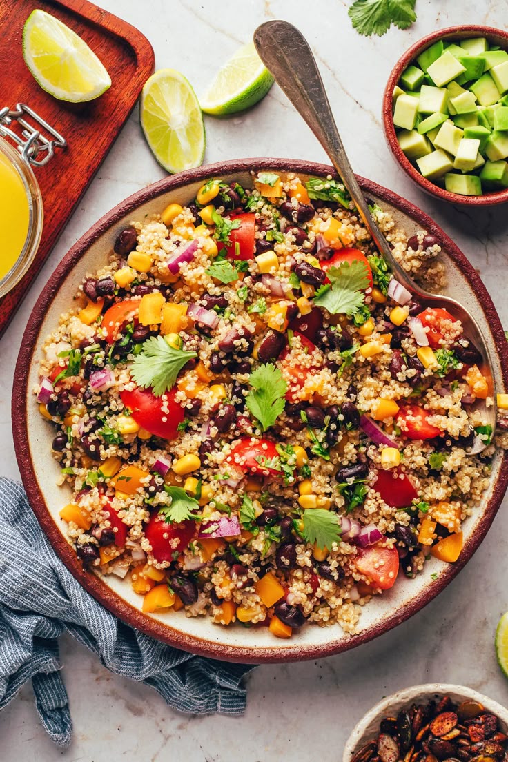 This may contain: a bowl filled with rice, beans and vegetables