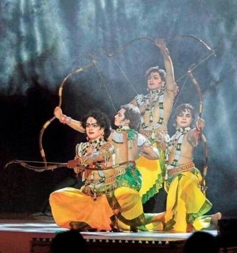 This may contain: some people are performing on stage with bow and arrows