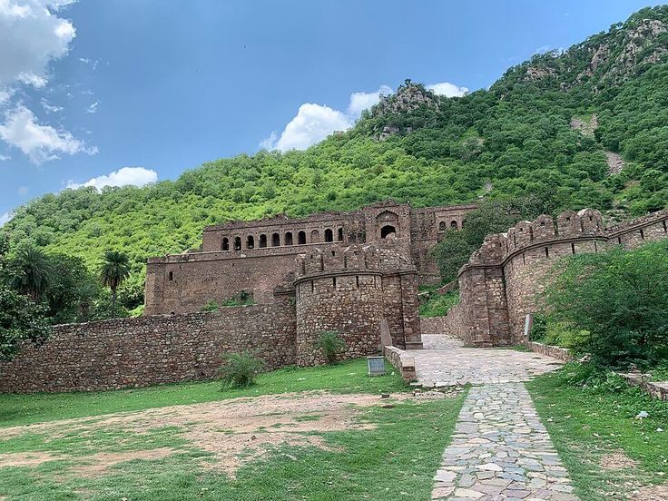 This may contain: an old stone castle on the side of a mountain