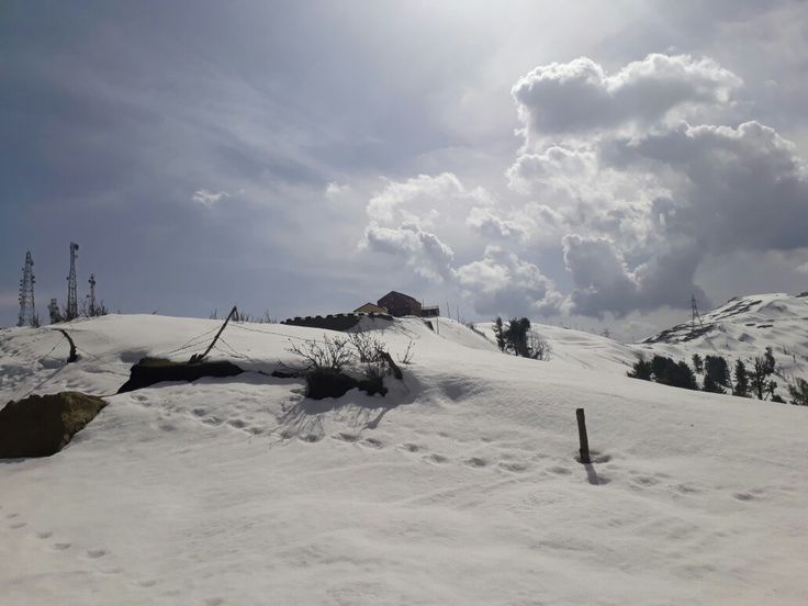 This may contain: the sun shines brightly on snow covered hills