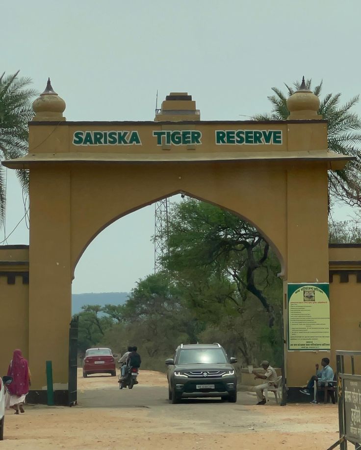 This may contain: cars are parked in front of the entrance to sariska tiger reserve, which is located on the outskirts of town