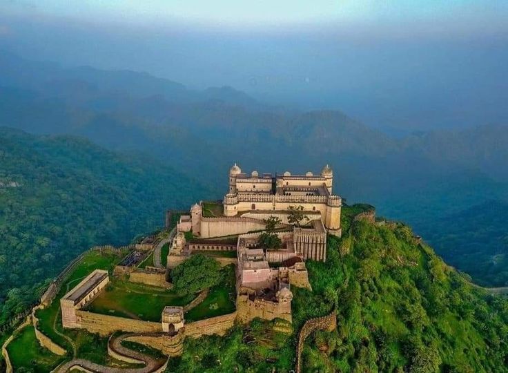 This may contain: an aerial view of a castle on top of a hill in the middle of nowhere