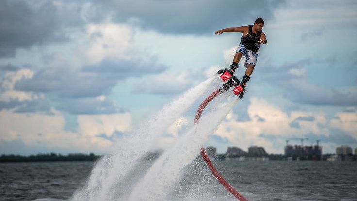 This may contain: a man riding a jet ski while being pulled by a boat