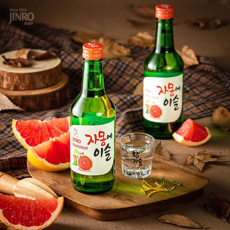 This may contain: two bottles of watermelon and grapefruit on a cutting board with slices of grapefruit