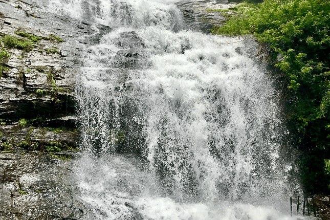 This may contain: a large waterfall with water cascading down it's sides