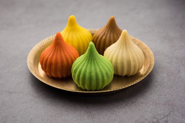 This may contain: three different colored sea shells sitting on a paper plate, one is yellow and the other is green