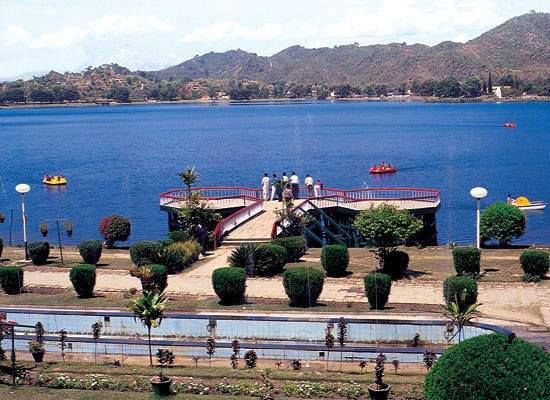 This may contain: people are standing at the end of a pier near a body of water with boats in it