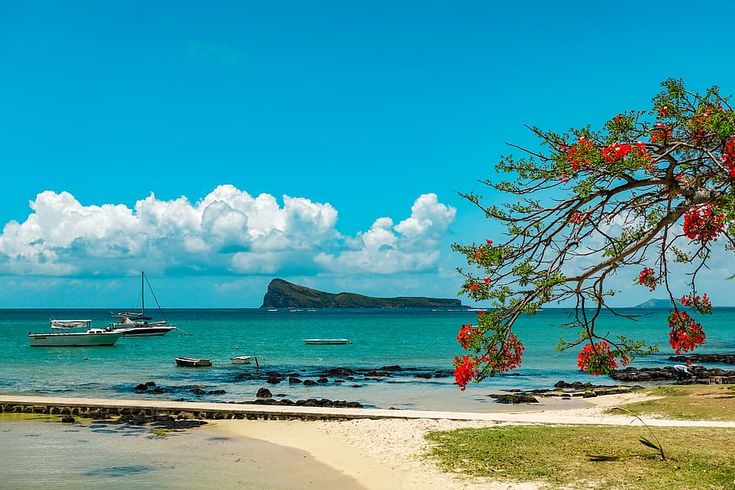 This may contain: boats are on the water near some rocks