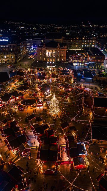 This may contain: an aerial view of christmas lights and decorations in the middle of a city at night