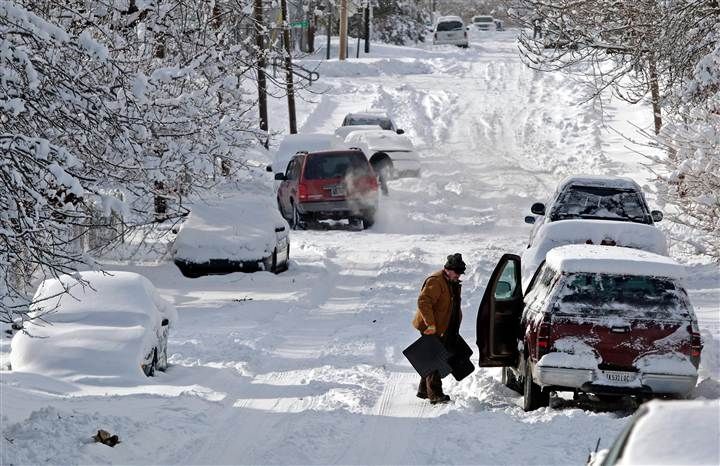 This may contain: cars are parked on the side of a snow covered road as people look at them