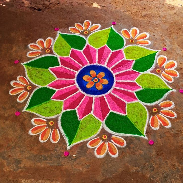 This may contain: a colorful flower design painted on the ground