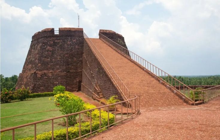 This may contain: a large brick structure with stairs leading up to it's top and another building in the background