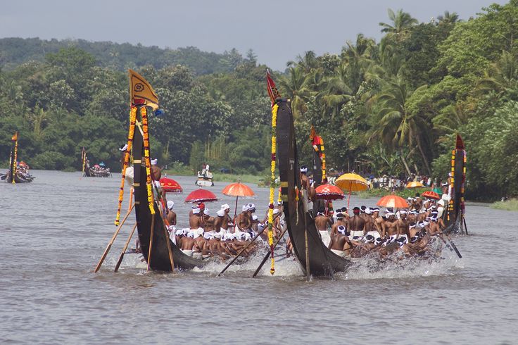 This may contain: a group of people riding on top of a boat in the water with umbrellas