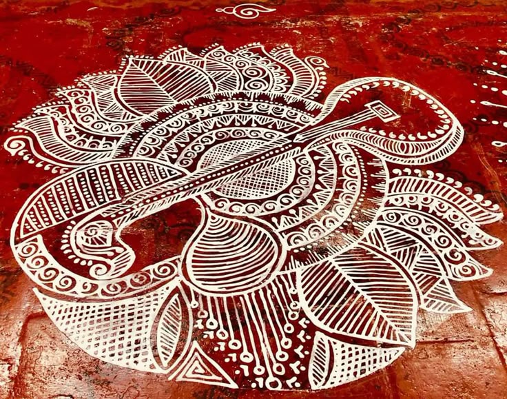 This may contain: a drawing on the side of a building with an intricate design in white and red