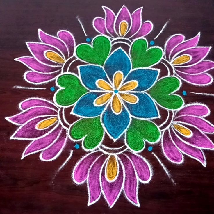 This may contain: a colorful flower design on a wooden surface