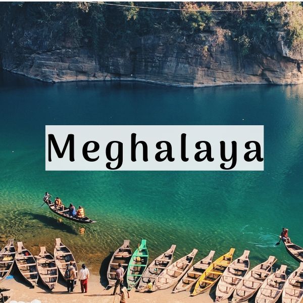 This may contain: several canoes are lined up on the shore with people standing near them and there is a sign that says meghalaya