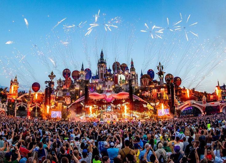 This may contain: a large group of people standing in front of a building with fireworks coming out of it