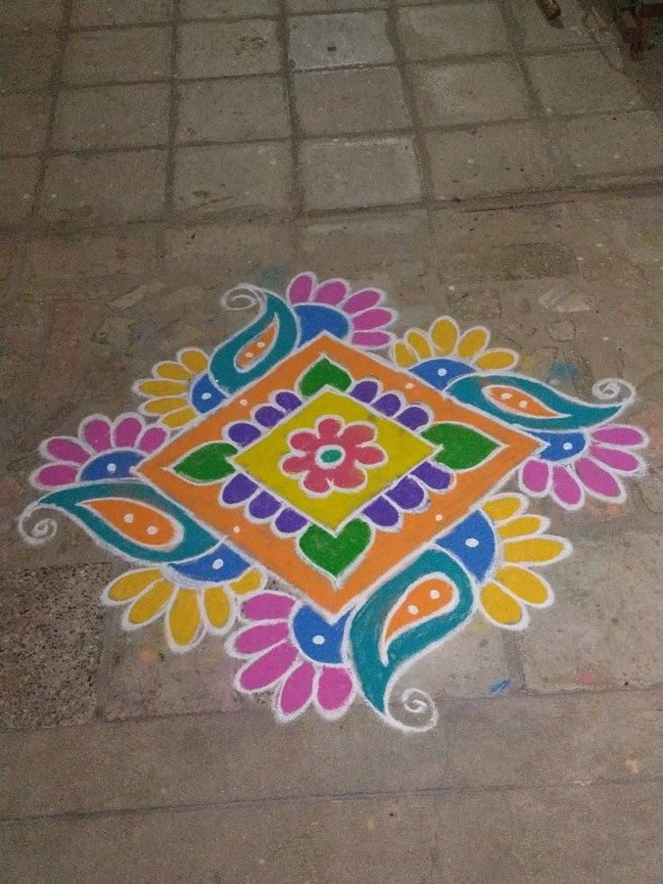 This may contain: a colorful design on the ground in front of a building