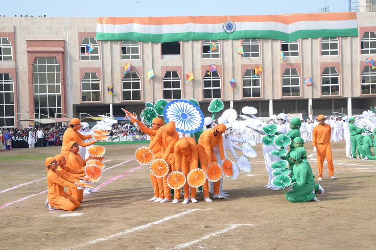 This may contain: a group of people in orange outfits standing on top of a field