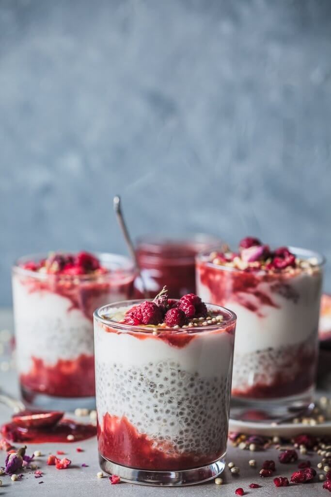 This may contain: three desserts with raspberries and oatmeal in them