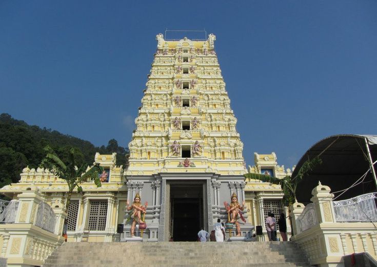 This may contain: a very tall building with statues on it's sides and stairs leading up to the entrance