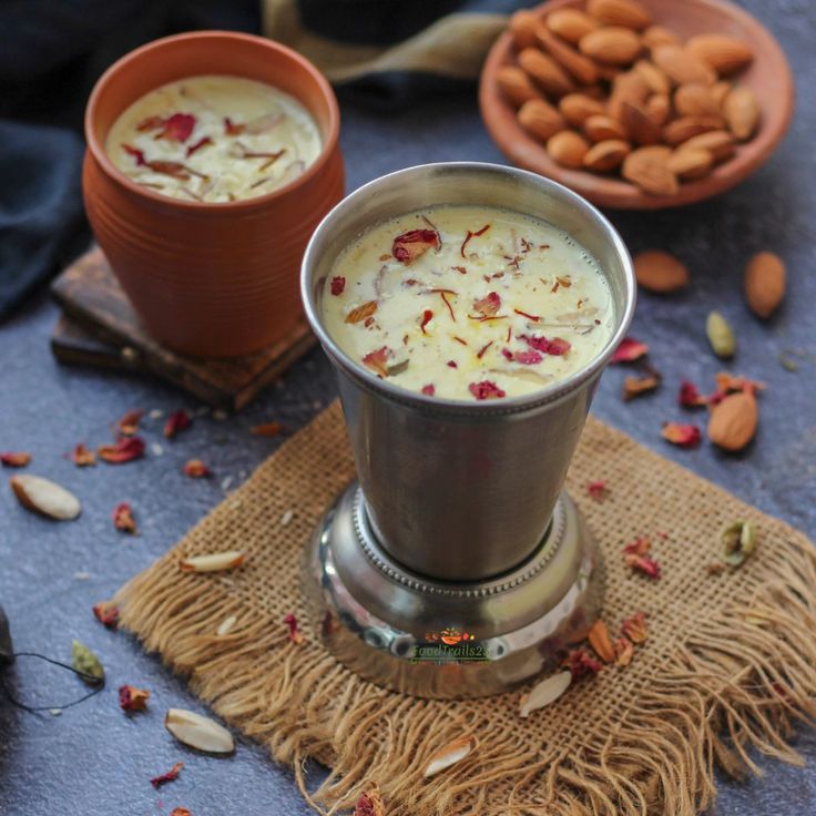 This may contain: two bowls filled with food sitting next to each other on top of a cloth covered table
