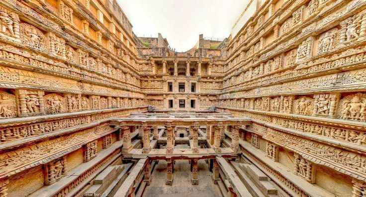 This may contain: an intricately carved building with many carvings on the walls and floor, in india