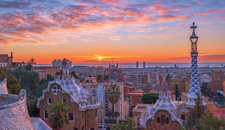 This may contain: the sun is setting over barcelona, spain as seen from atop gaudina's roof