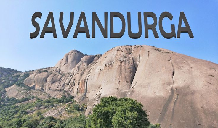 This may contain: the words savandurga written in black on top of a mountain with trees