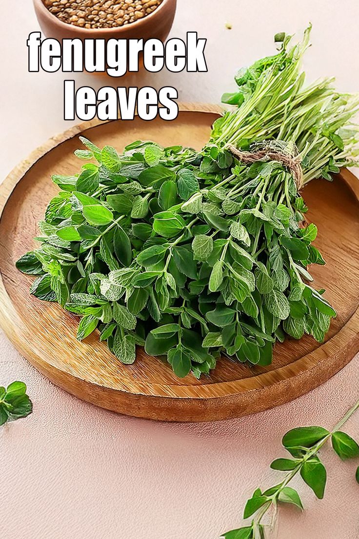 This may contain: fresh herbs on a wooden plate with the words fenugreek leaves above it