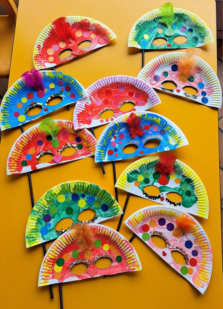 This may contain: paper plate masks are lined up on a table