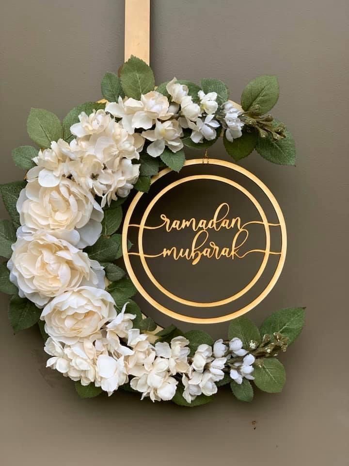 This may contain: a wreath with flowers hanging on the wall