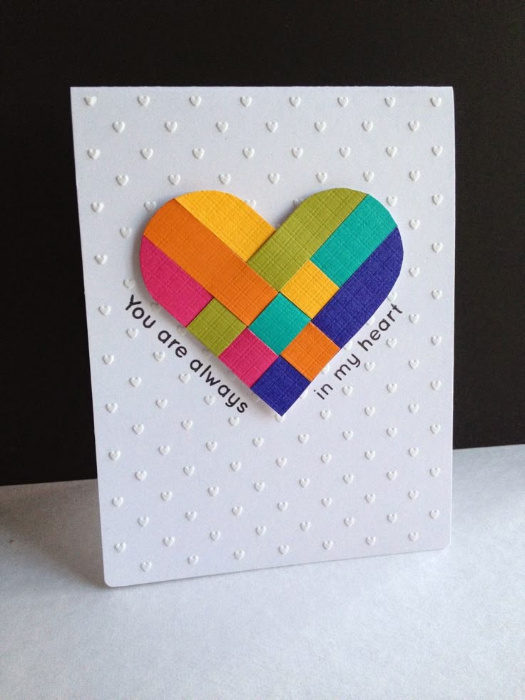 This may contain: a card with a colorful heart on it