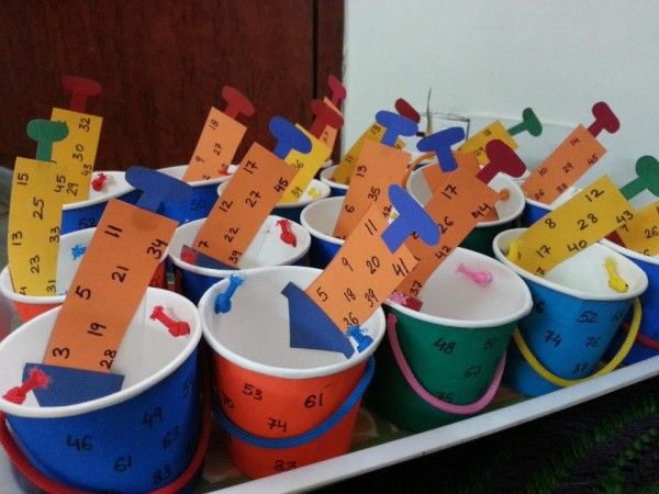 This may contain: buckets filled with different colored paper cups and numbers on the top one is labeled