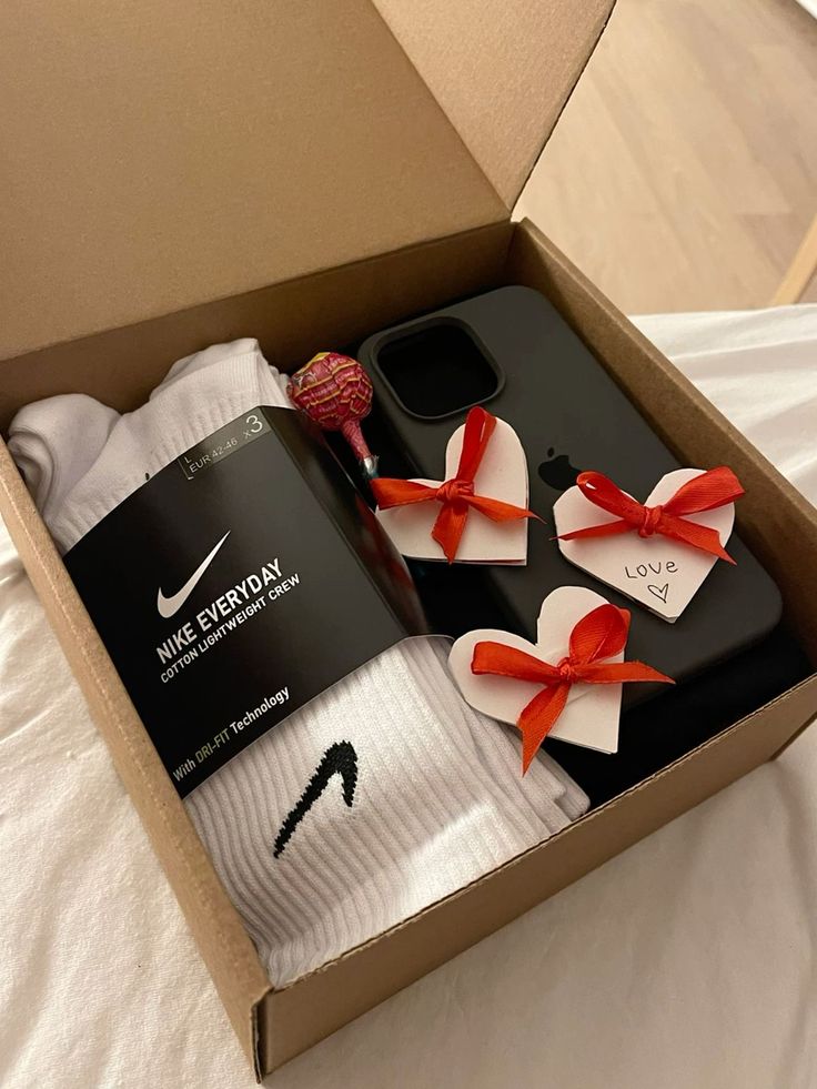 This may contain: a box with two pairs of nike socks and one pair of red bow tie on it