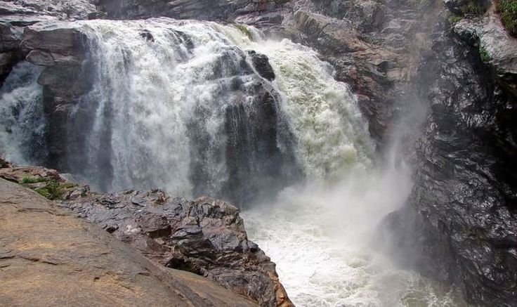 This may contain: a large waterfall with lots of water coming out of it