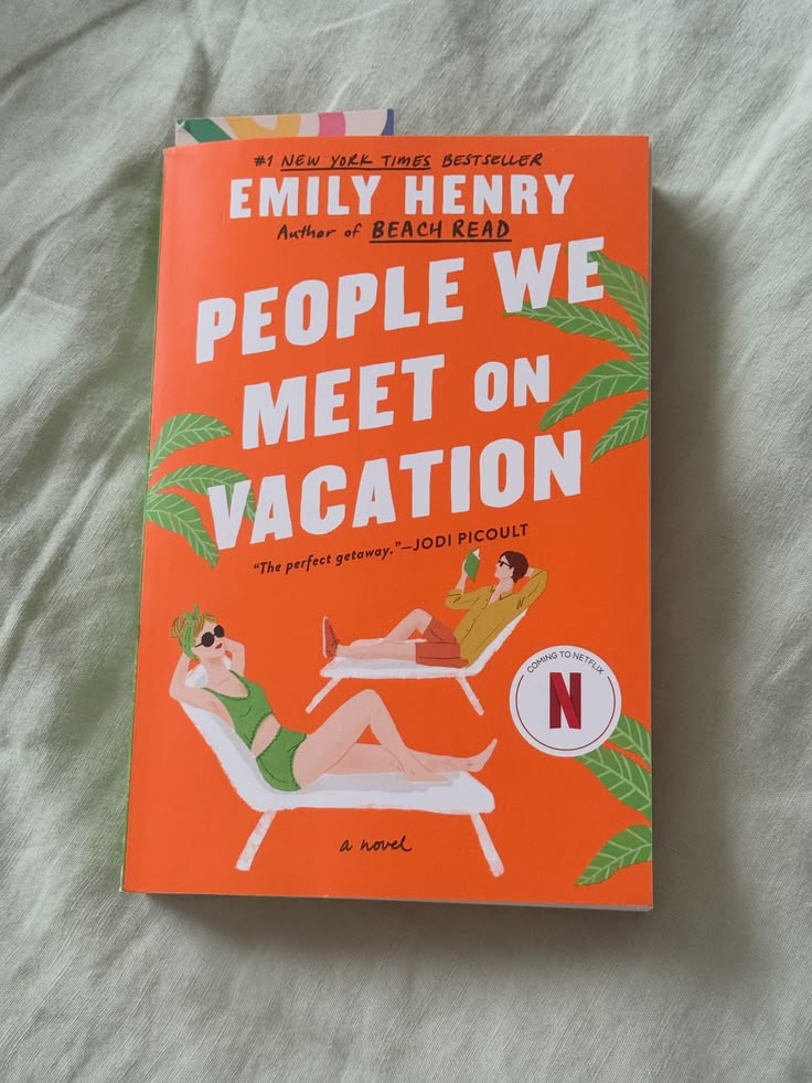 This may contain: the book people we meet on vacation is laying on a bed