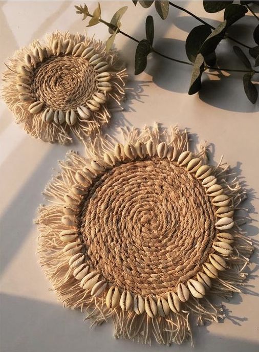 This may contain: two woven sunflowers sitting on top of a table