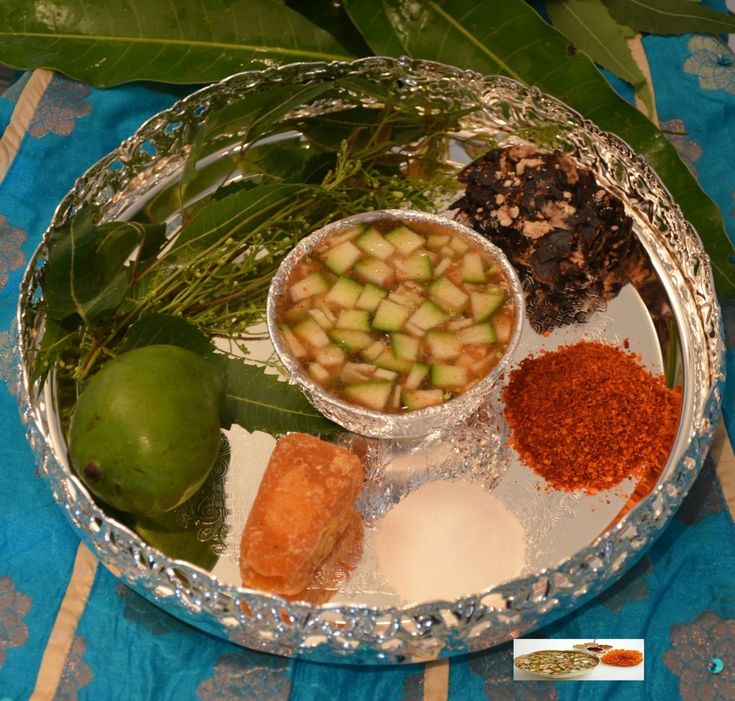 This may contain: a metal plate topped with different types of food on top of a blue table cloth
