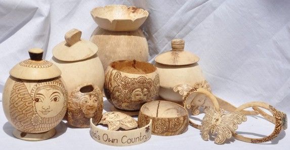This may contain: an assortment of carved wooden items including jars, bowls and spoons on a white background