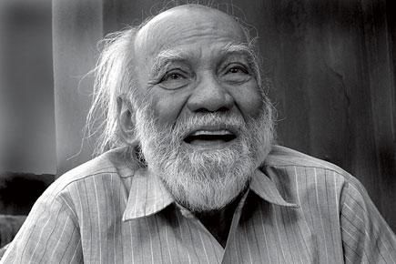 This may contain: an old man with white hair and beard wearing a striped shirt