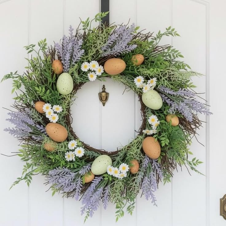 This may contain: a wreath with eggs and flowers on the front door
