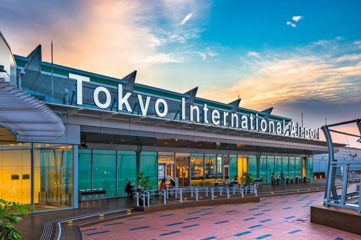 This may contain: the entrance to tokyo international airport at sunset