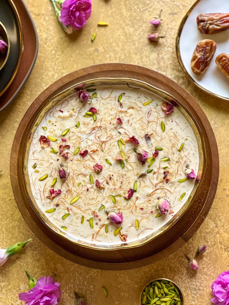 This may contain: a bowl filled with food sitting on top of a table next to other bowls and spoons