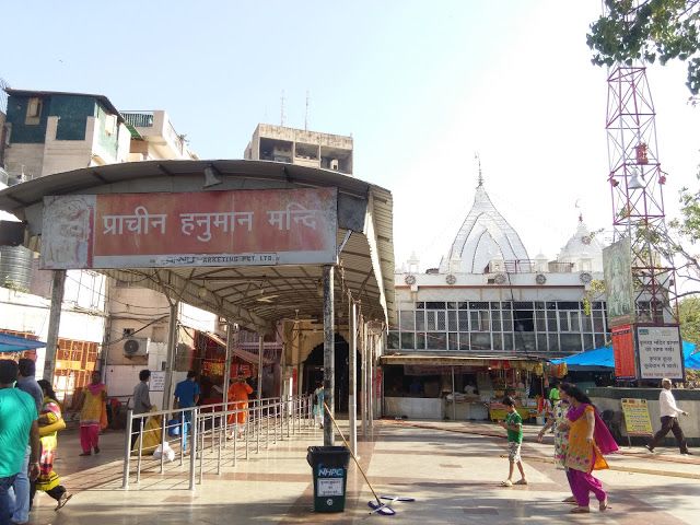 This may contain: people are walking around in front of a building