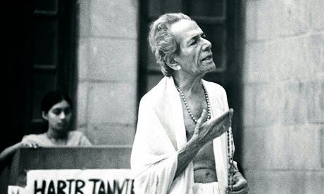 This may contain: an old woman standing in front of a building