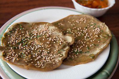 This may contain: two pancakes on a plate with sesame seeds