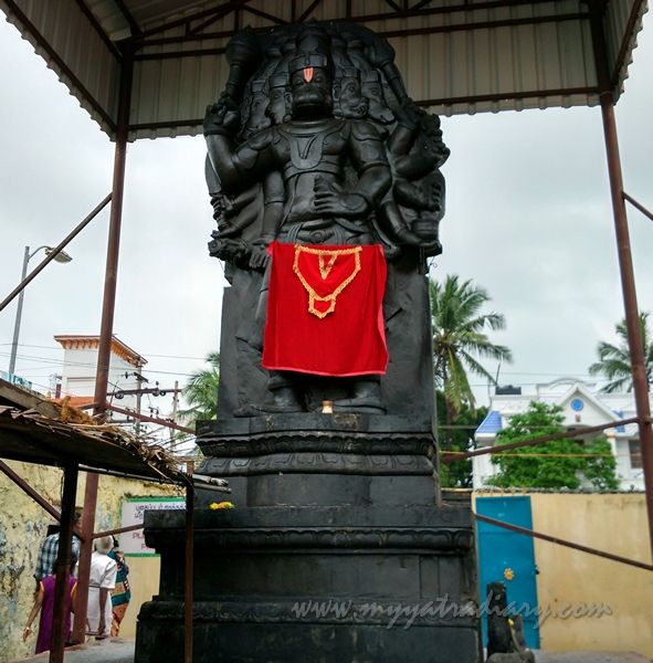 This may contain: a statue with a red cloth hanging from it's side