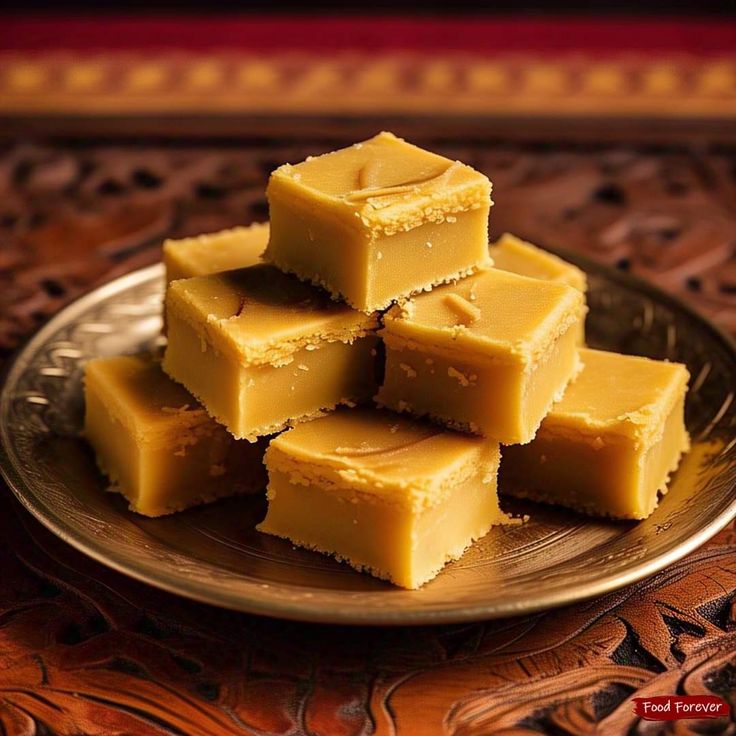This may contain: several pieces of yellow fudge on a plate